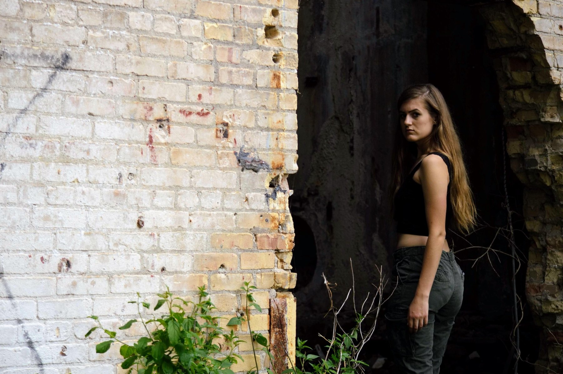 Portrait framed by a rough brick doorway
