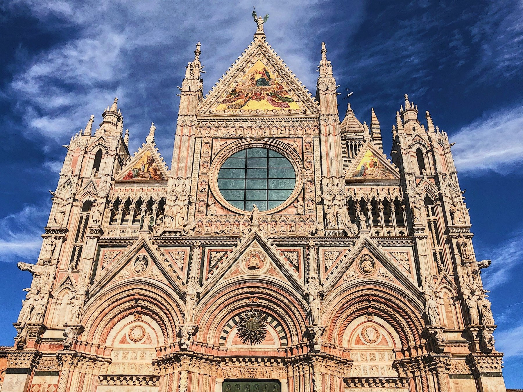 Ornate cathedral facade beneath a saturated blue sky