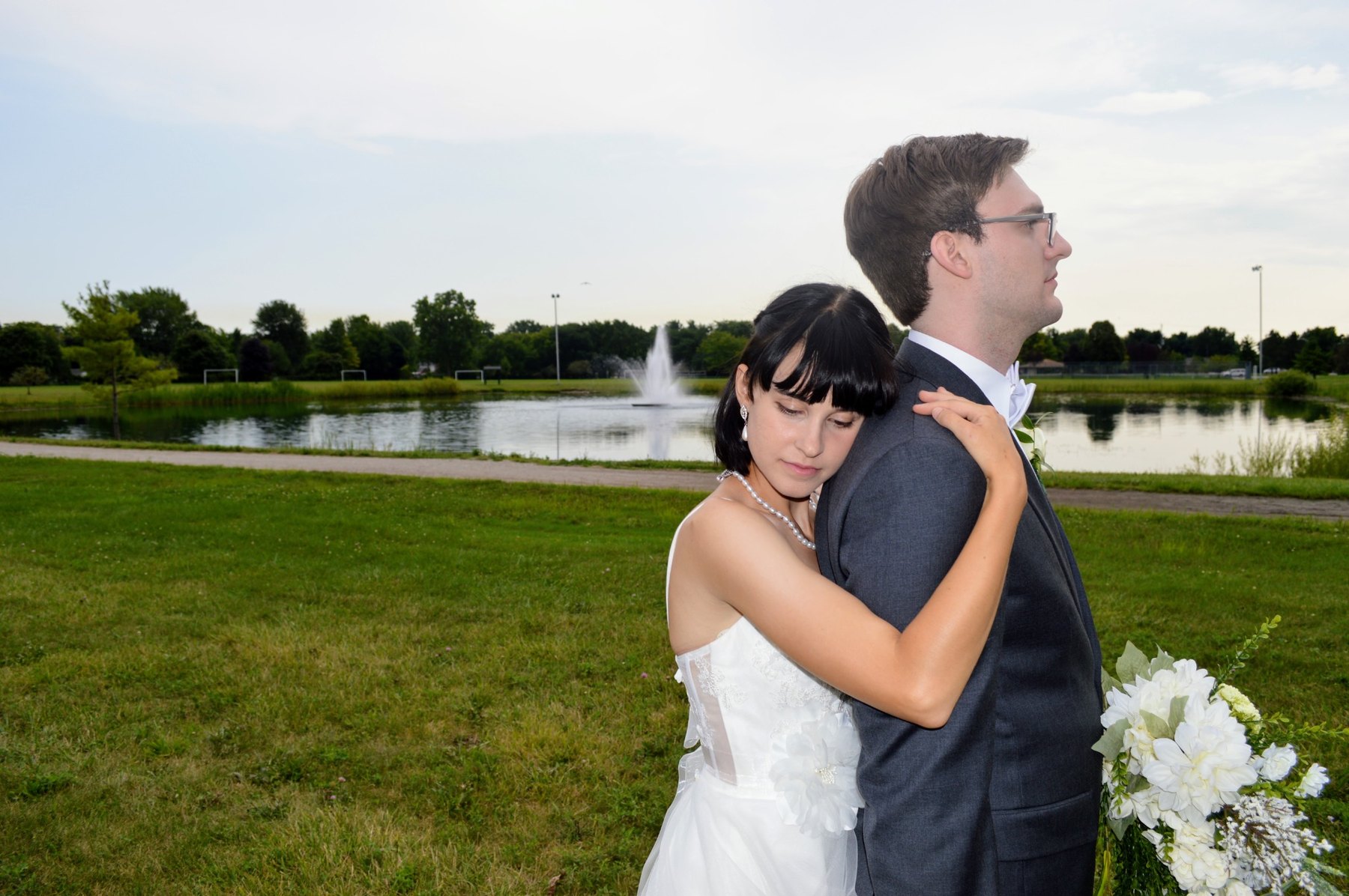 Wedding couple embracing in a quiet outdoor moment